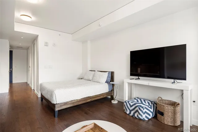 a bedroom with a bed and a flat screen tv