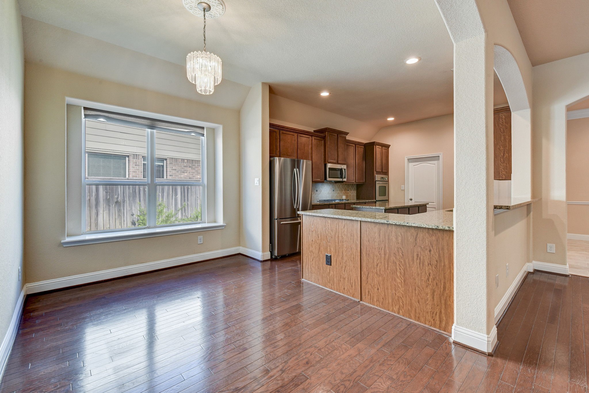 39 South Pinto Point Circle Spring, TX 77389 - Photo 13 of 48 a view of kitchen with wooden floor and window
