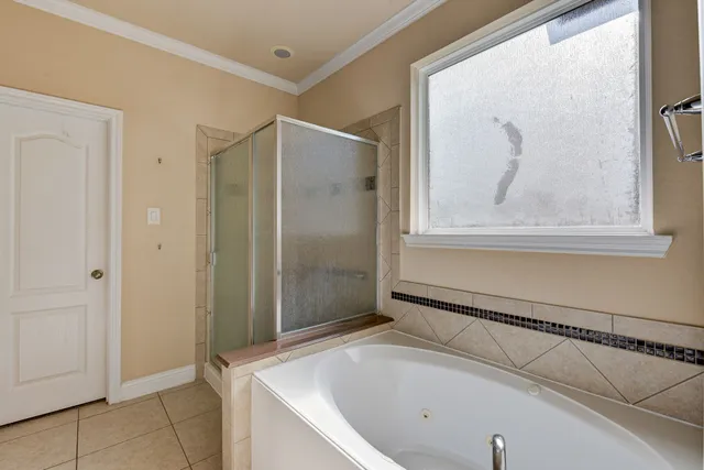 a bathroom with a tub and shower