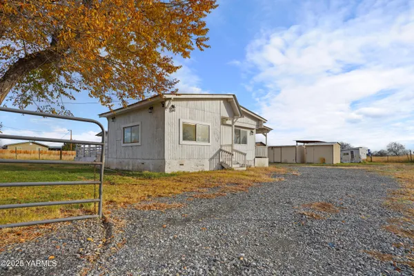 a backyard of a house with wooden floor and fence
