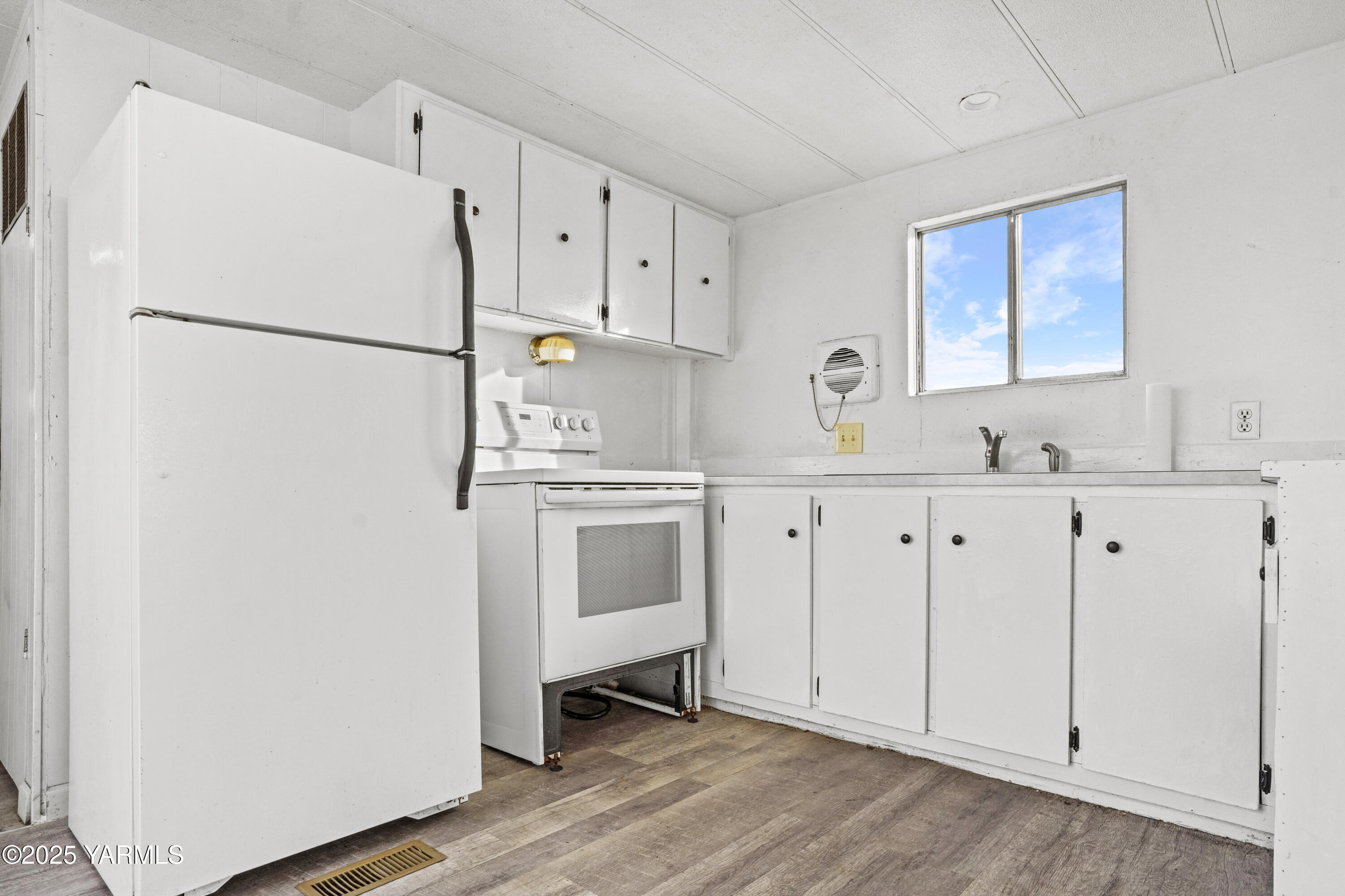 1081 Tecumseh Road White Swan, WA 98952 - Photo 8 of 16 a kitchen with white cabinets and white appliances
