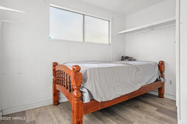 a bedroom with a bed and a shower