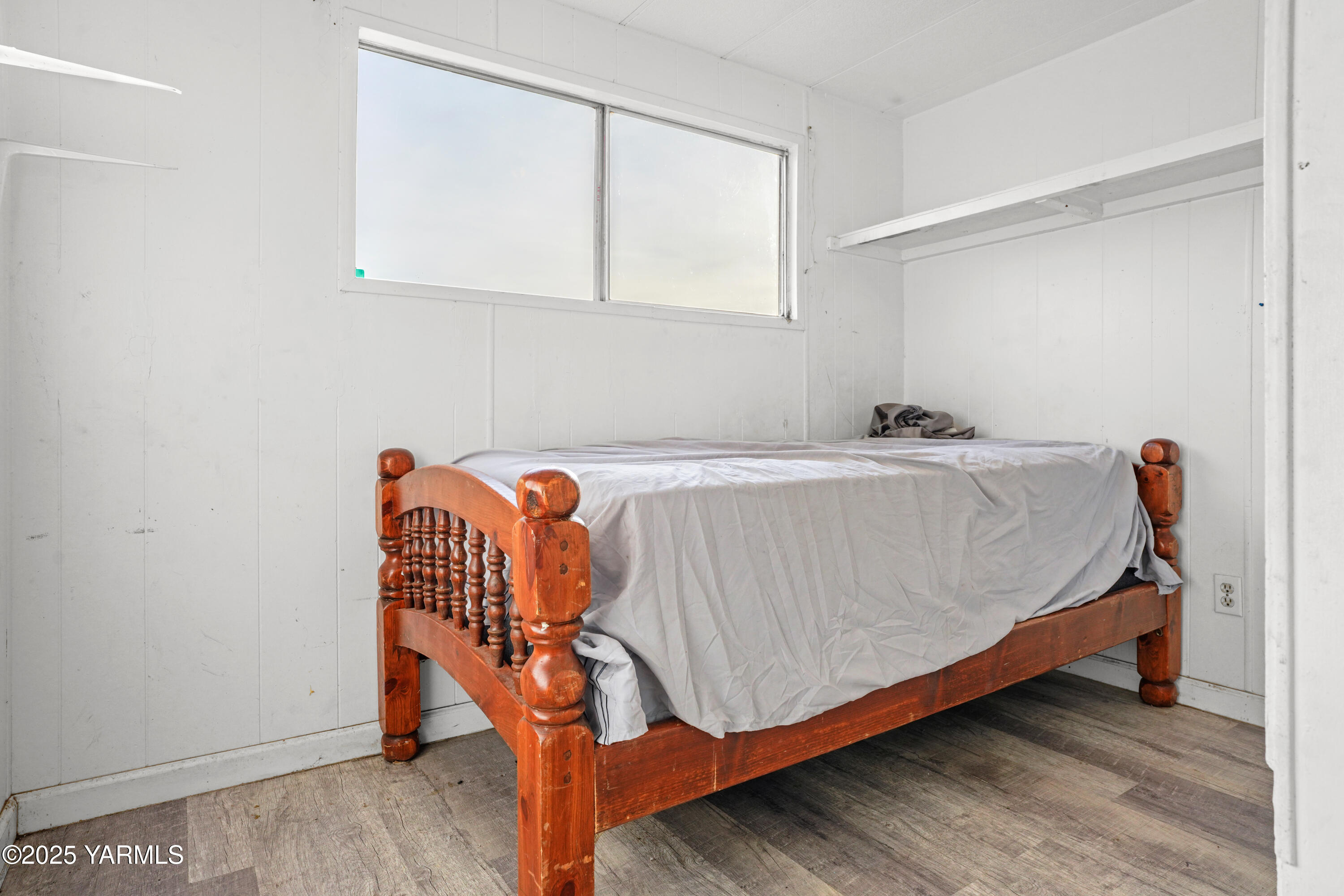 1081 Tecumseh Road White Swan, WA 98952 - Photo 10 of 16 a bed sitting in a bedroom next to a window