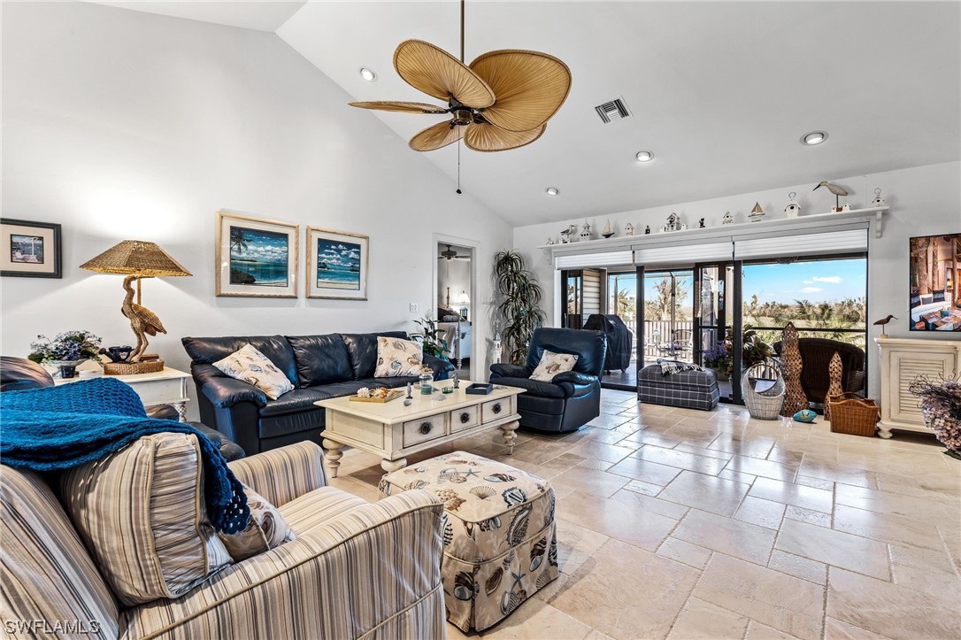 1578 Sand Castle Road Sanibel, FL 33957 - Photo 5 of 42 a living room with furniture kitchen view and a chandelier