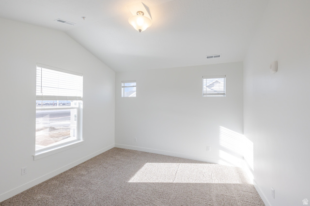 4662 Poplar Way, Unit Q301 Mapleton, UT 84664 - Photo 16 of 18 Empty room with light colored carpet and lofted ceiling