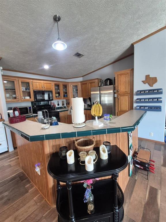 438 Silver River Road Gholson, TX 76705 - Photo 16 of 39 a kitchen with a stove and a dining table