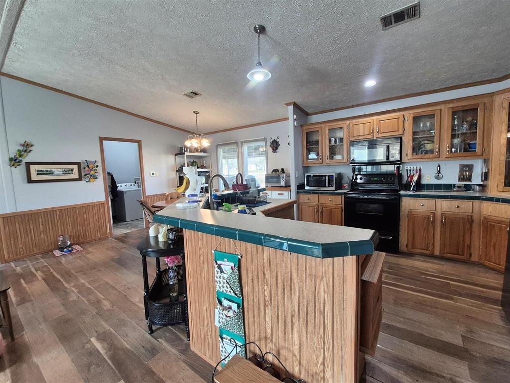 438 Silver River Road Gholson, TX 76705 - Photo 17 of 39 a kitchen with stainless steel appliances granite countertop a stove and a refrigerator