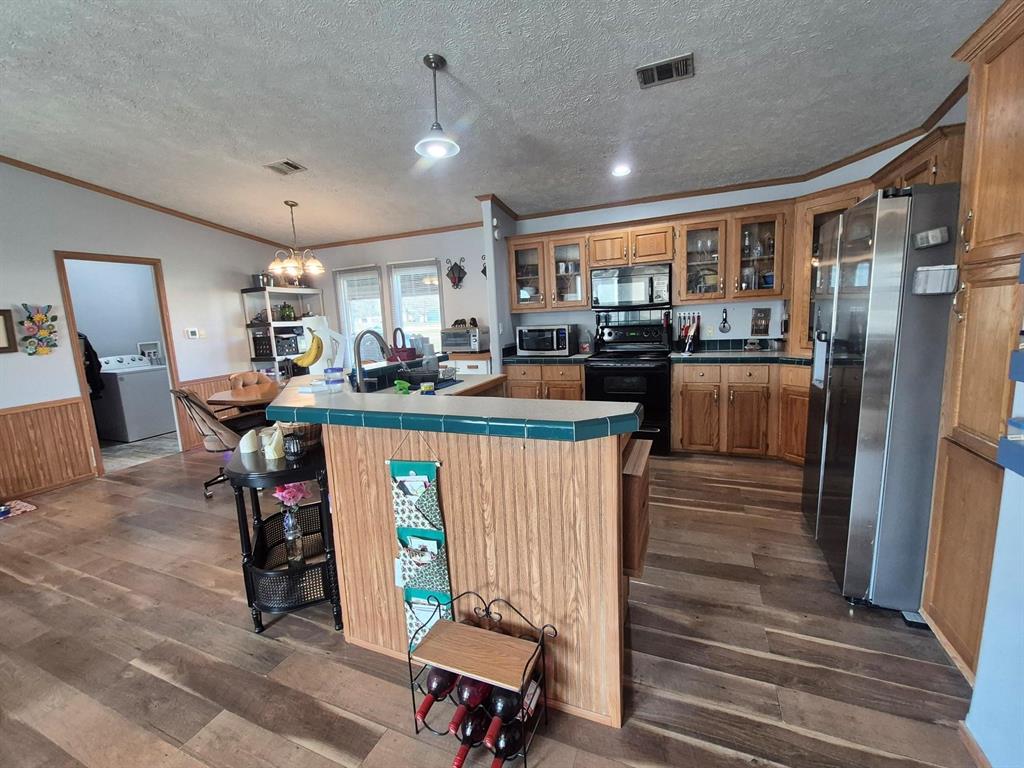 438 Silver River Road Gholson, TX 76705 - Photo 19 of 39 a dining hall with stainless steel appliances granite countertop a stove and a refrigerator