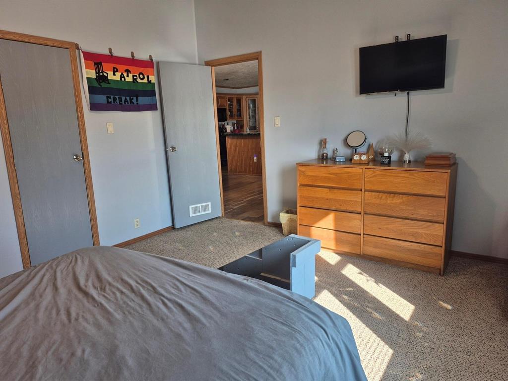 438 Silver River Road Gholson, TX 76705 - Photo 32 of 39 a bedroom with a bed and a flat screen tv