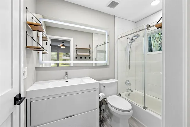 a bathroom with a sink toilet and shower