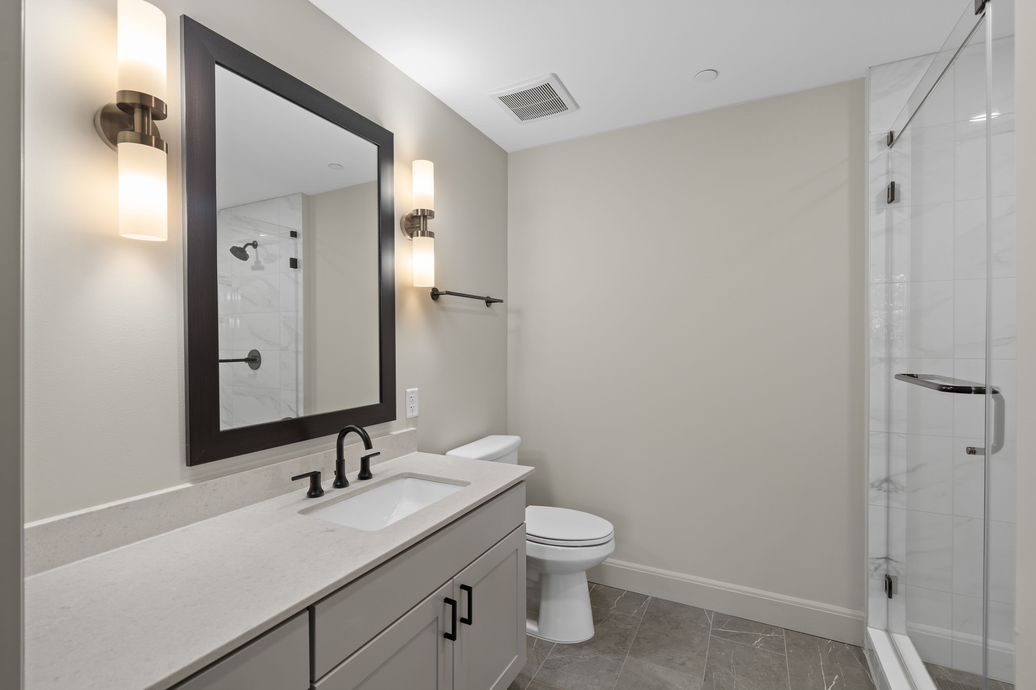 2511 Willowick Road, Unit 539 Houston, TX 77027 - Photo 12 of 45 a bathroom with a granite countertop sink toilet and mirror