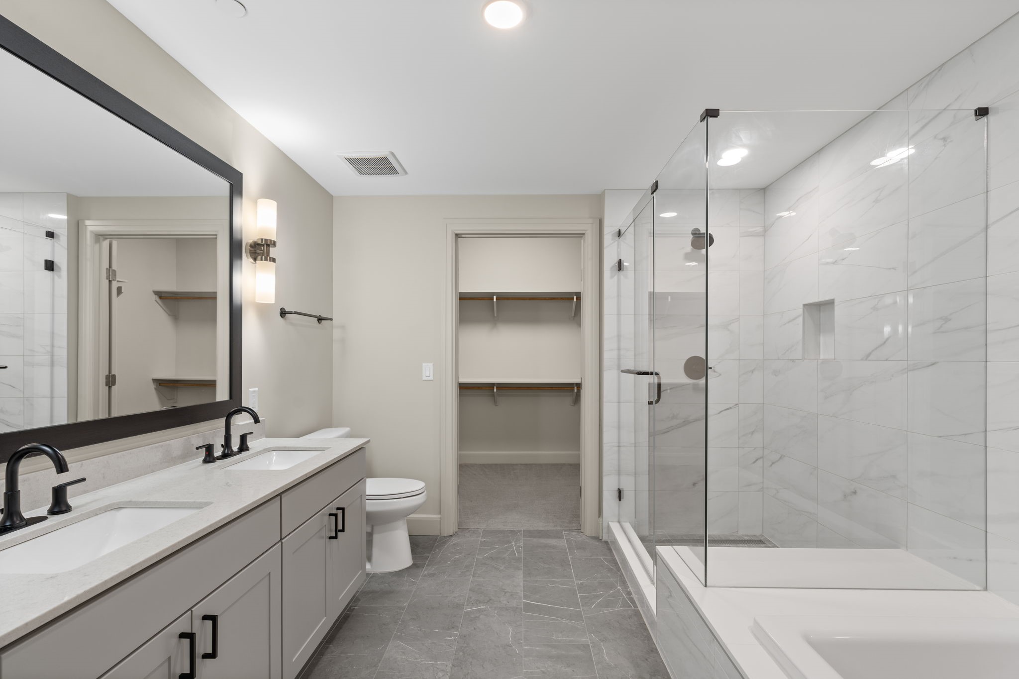 2511 Willowick Road, Unit 539 Houston, TX 77027 - Photo 17 of 45 a bathroom with a double vanity sink toilet and shower