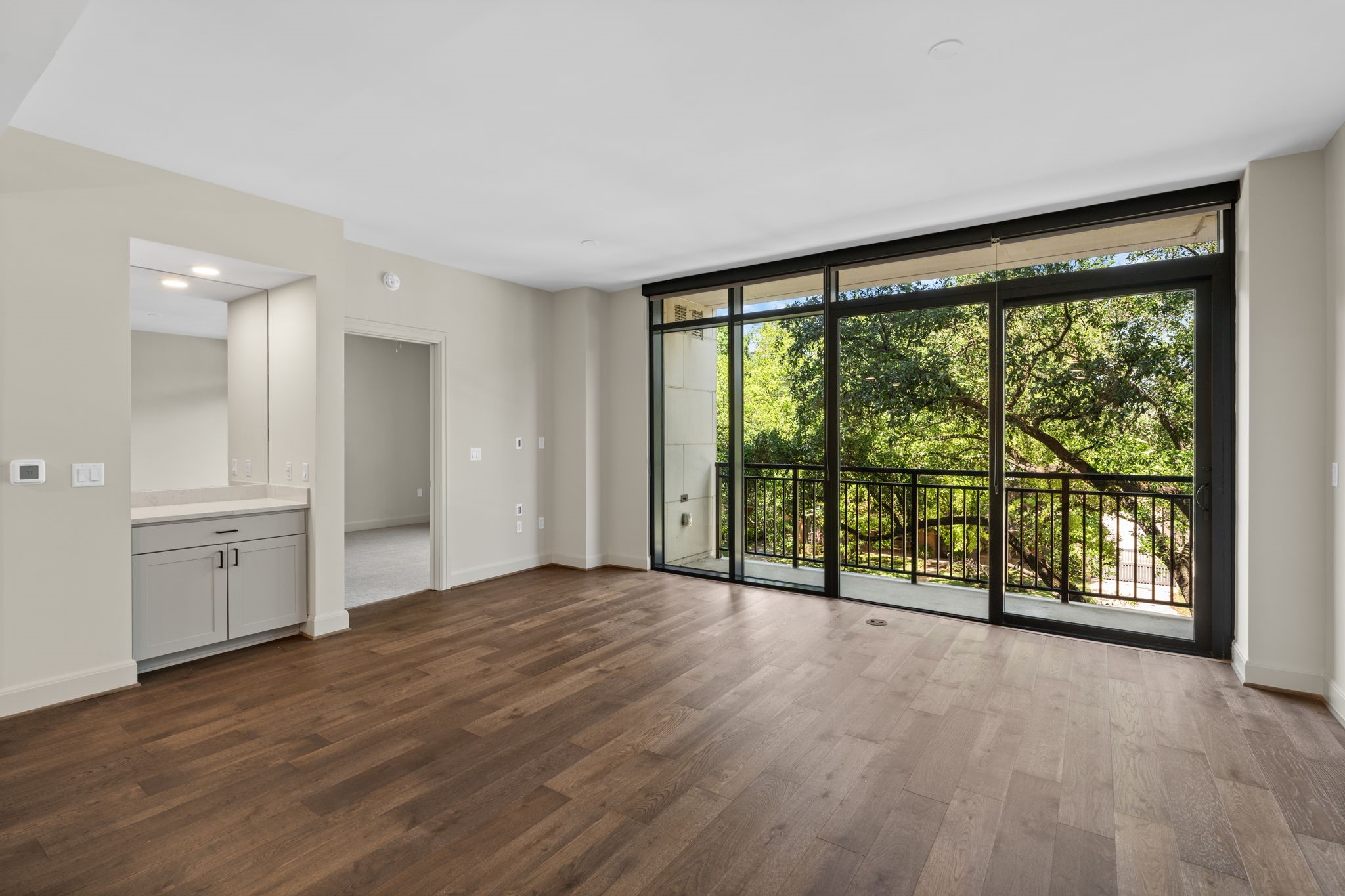 2511 Willowick Road, Unit 539 Houston, TX 77027 - Photo 6 of 45 a view of an empty room with a window and wooden floor