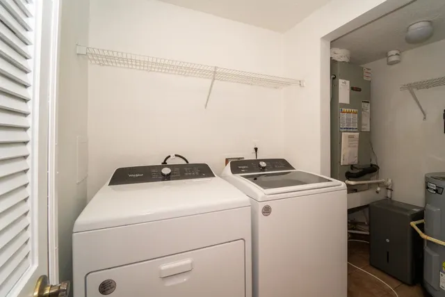 a front view of a house with a yard garage and large trees