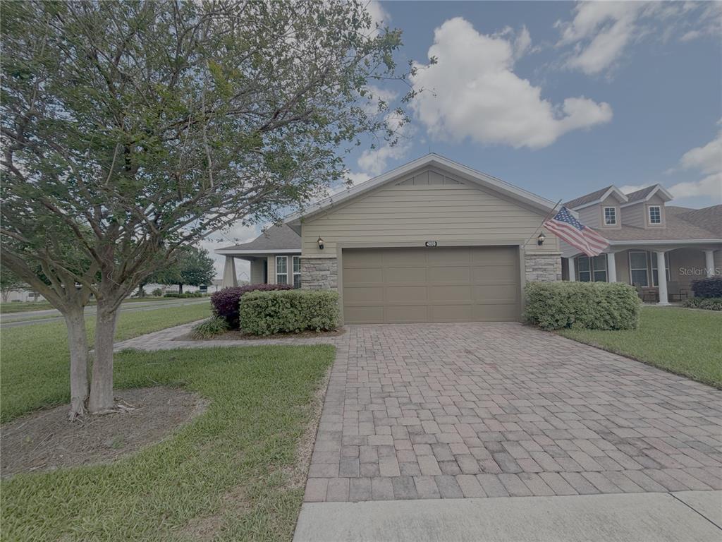 a front view of a house with a yard and trees