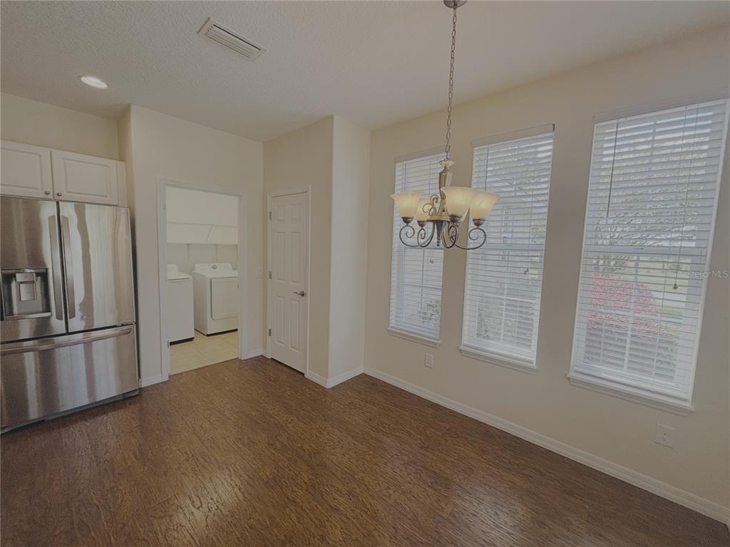 4859 Northwest 35th Ln Road Ocala, FL 34482 - Photo 13 of 30 a view of a kitchen with a refrigerator and a window
