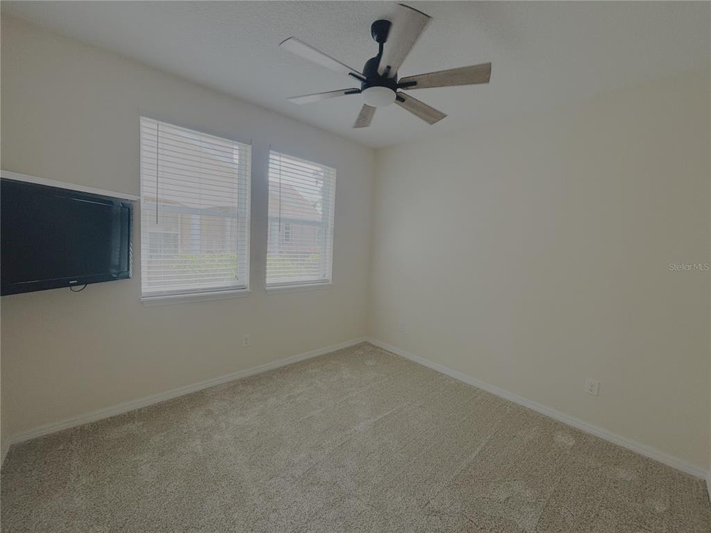 4859 Northwest 35th Ln Road Ocala, FL 34482 - Photo 22 of 30 an empty room with a window and a fan