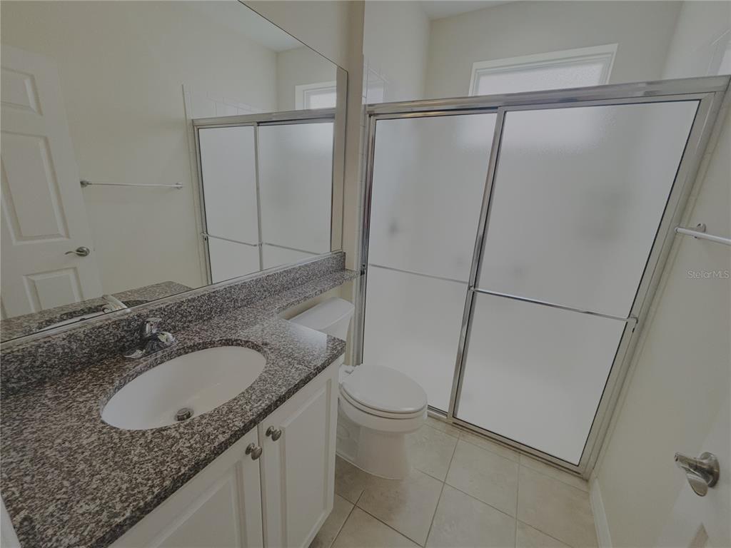 4859 Northwest 35th Ln Road Ocala, FL 34482 - Photo 24 of 30 a bathroom with a granite countertop sink and mirror