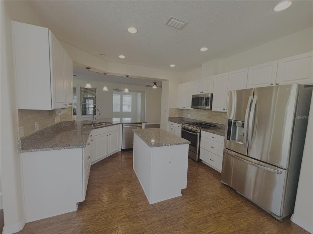 4859 Northwest 35th Ln Road Ocala, FL 34482 - Photo 4 of 30 a large kitchen with a refrigerator and a sink
