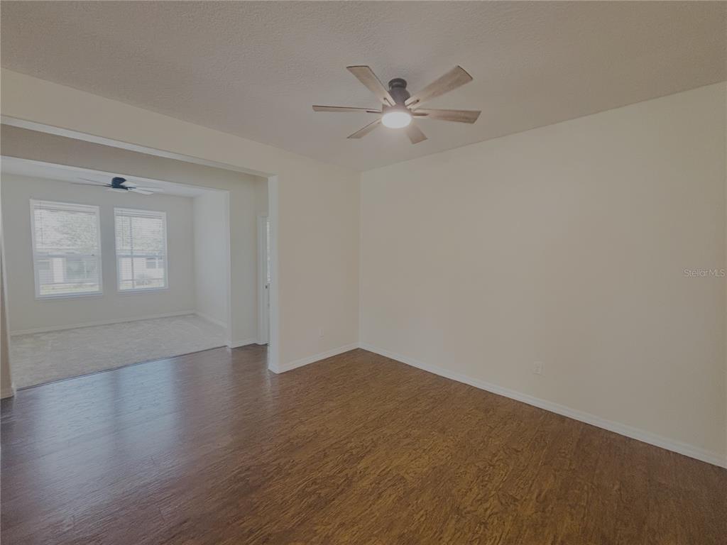 4859 Northwest 35th Ln Road Ocala, FL 34482 - Photo 6 of 30 a view of an empty room with wooden floor and a window