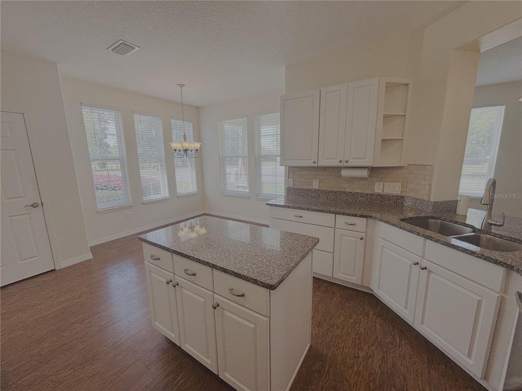 4859 Northwest 35th Ln Road Ocala, FL 34482 - Photo 8 of 30 a kitchen with granite countertop white cabinets and sink