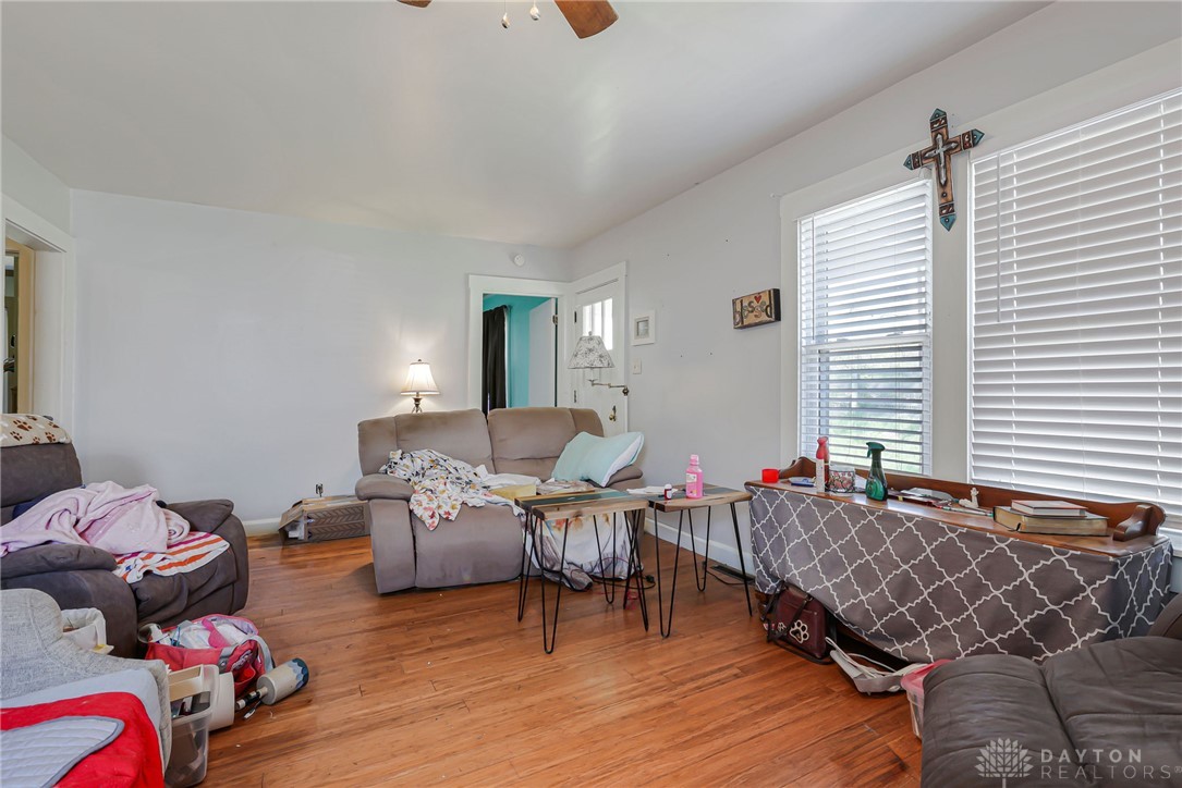 2390 Ridge Road Zanesville, OH 43701 - Photo 11 of 45 This living room features rich wood flooring, natural light, and a refreshing ceiling fan.