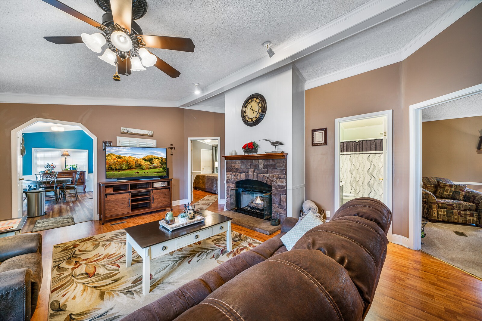 270 Allen's Chapel Road Smithville, TN 37166 - Photo 9 of 26 a living room with furniture a fireplace and a flat screen tv