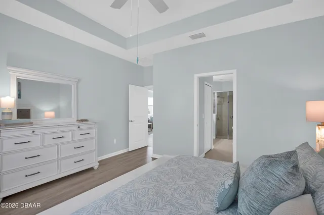 a bedroom with a large bed and a chandelier