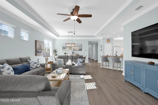 a kitchen with granite countertop a sink stainless steel appliances and white cabinets