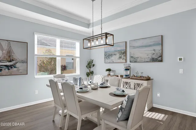 a view of a dining room with furniture and wooden floor