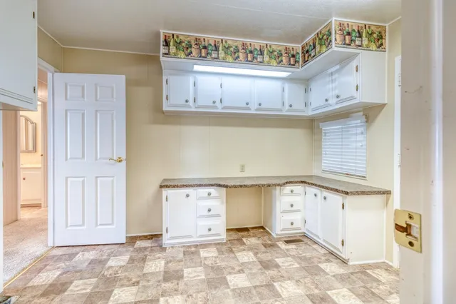 a view of a utility room with cabinets