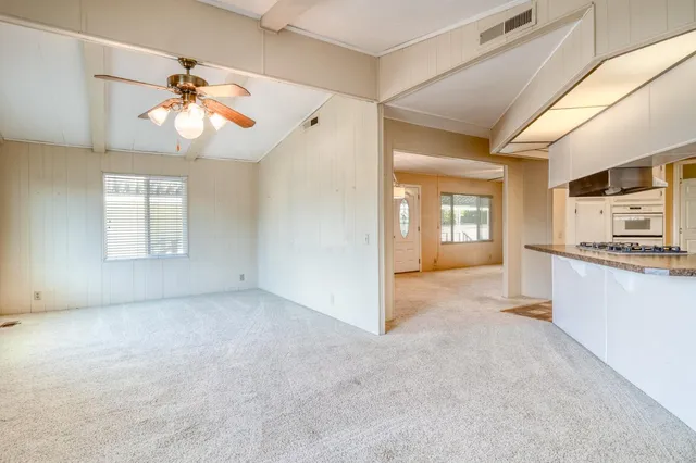 a view of an empty room with window and cabinet