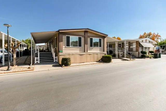 a front view of a house with a road
