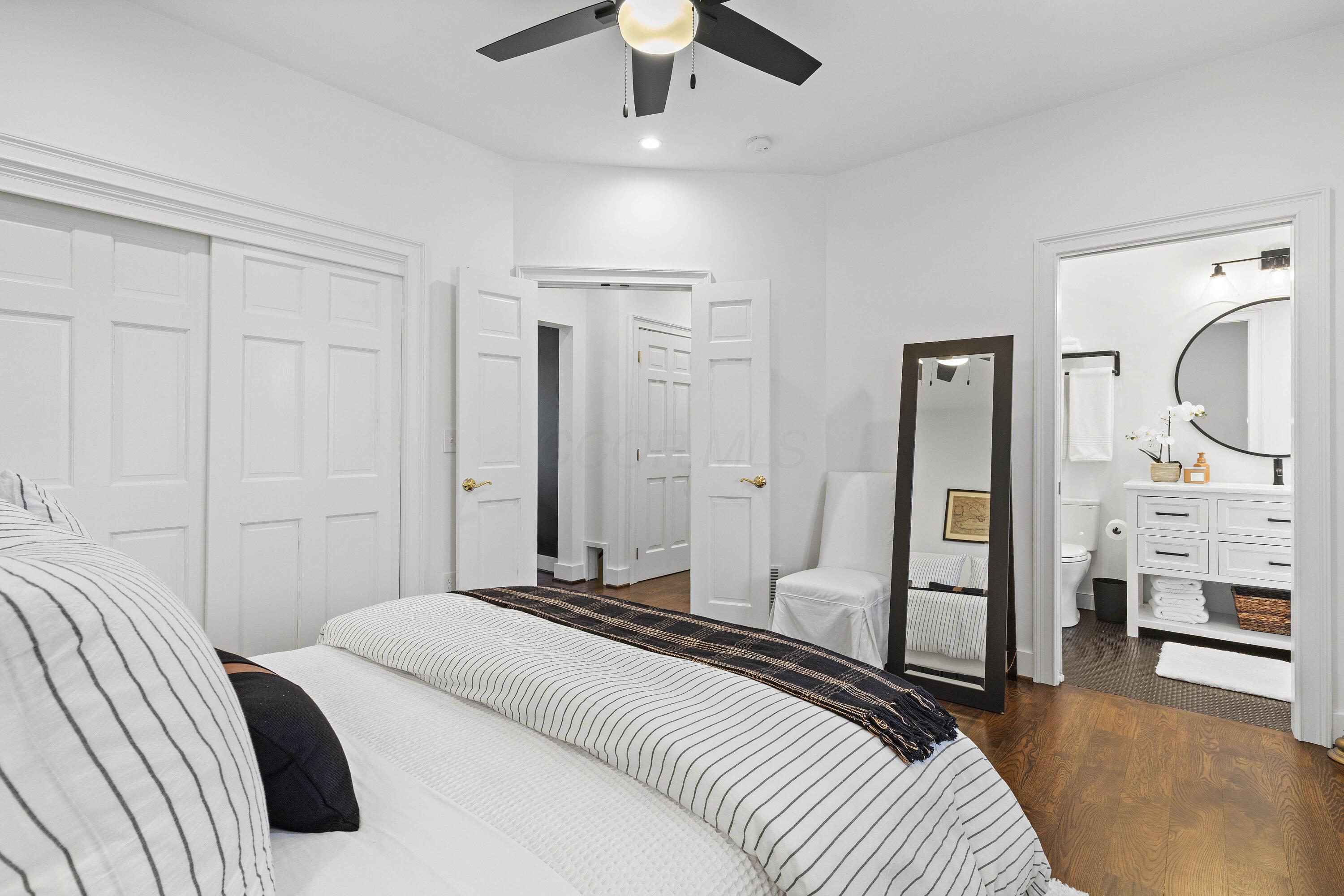 1364 Dale Ford Road Delaware, OH 43015 - Photo 25 of 112 • Hardwood flooring • White painted walls • Can lighting • Lighted ceiling fan • Bay wall • Closet with double sliding doors • Closet organizer • Wall lights are negotiable • French door to hall