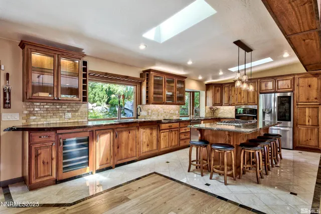 a bedroom with a bed a dresser with wooden floor