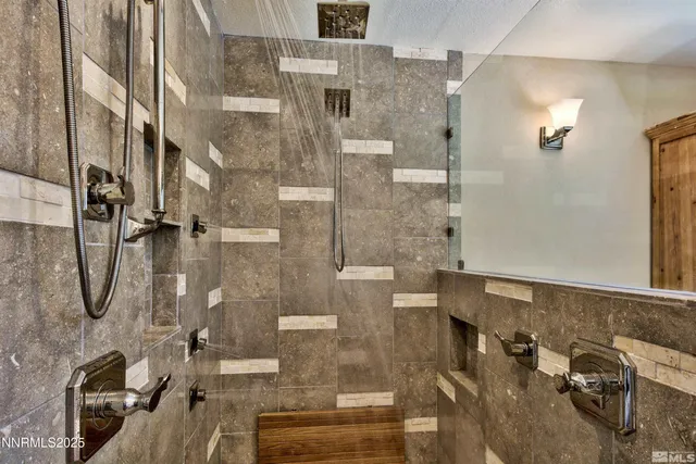 a view of a living room with a floor to ceiling window and wooden floor