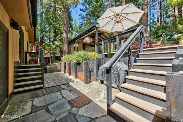 a front view of a house with a yard and large trees
