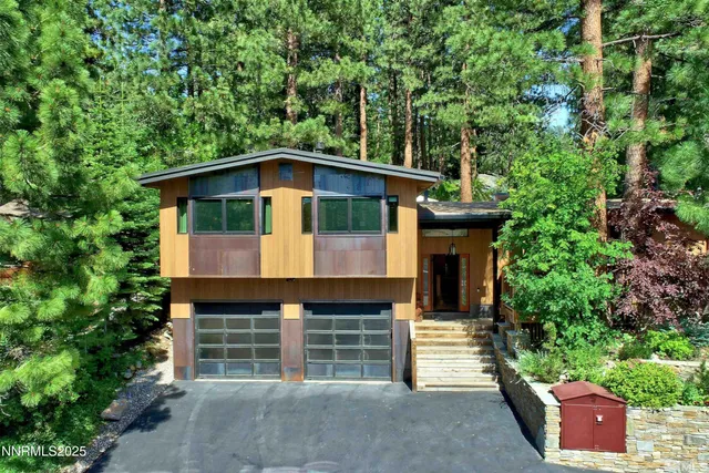 a view of staircase with railing and a chandelier