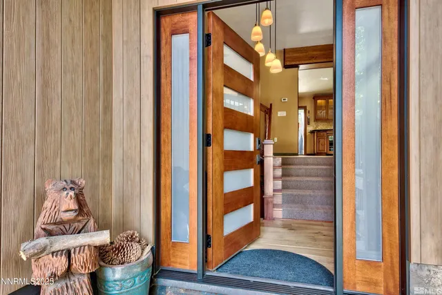 a view of a living room and floor to ceiling windows