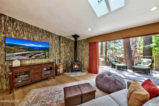 a kitchen with stainless steel appliances granite countertop a kitchen island a stove a table and chairs