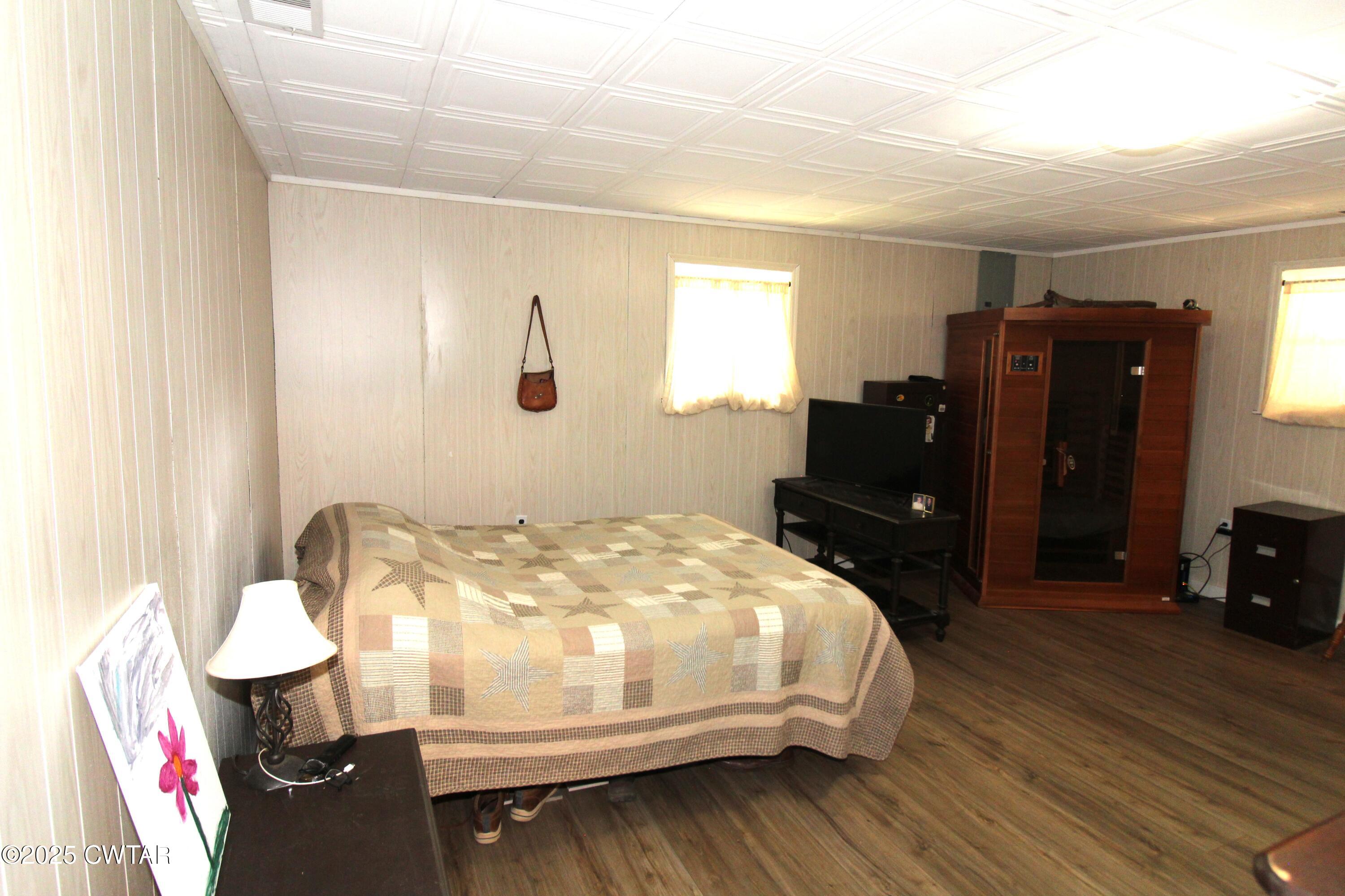 152 Hunter Jones Road Milan, TN 38358 - Photo 18 of 31 a bedroom with a bed and wooden floor