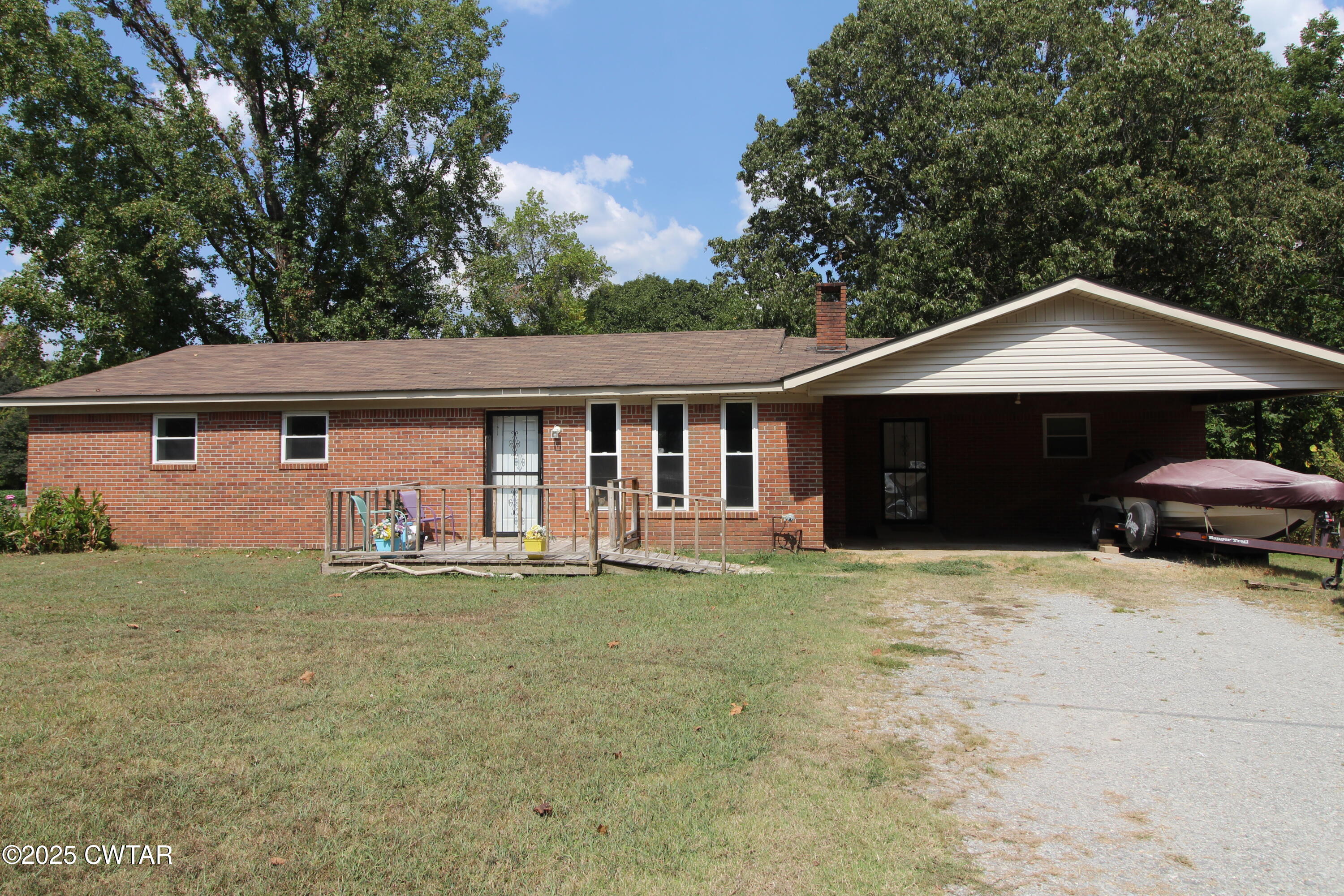 152 Hunter Jones Road Milan, TN 38358 - Photo 2 of 31 a front view of a house with a garden and trees