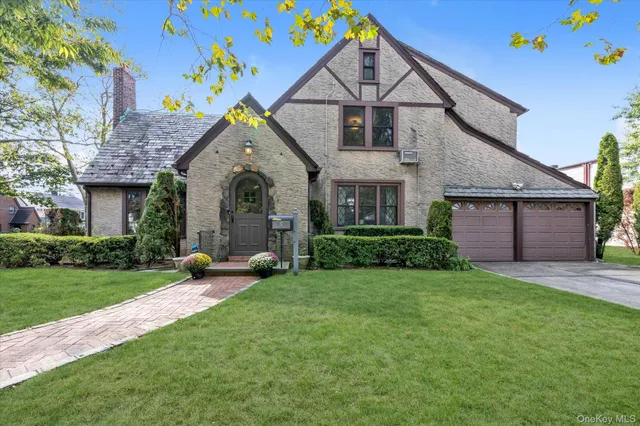 a front view of a house with a yard and garage