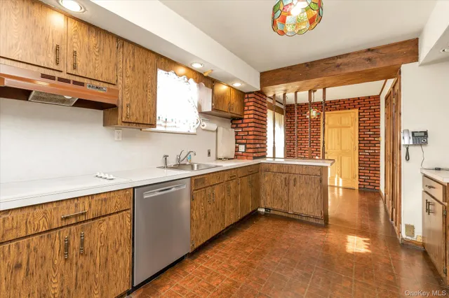 a kitchen with a refrigerator a sink and wooden cabinets