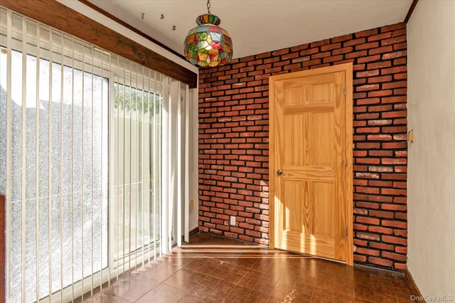 a view of a hallway with wooden floor and a window