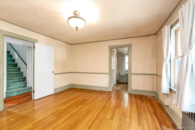 a view of a room with wooden floor and staircase