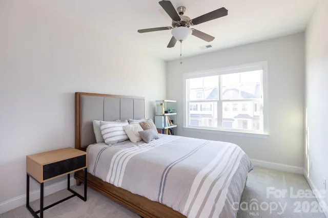 a bedroom with a bed and window