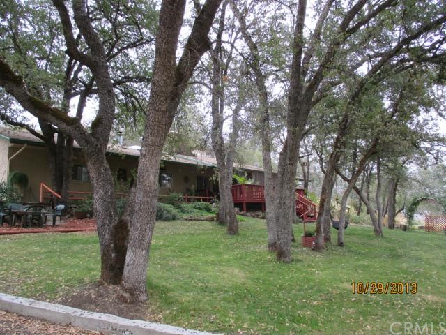 3807 Cir J Road Butte Valley, CA 95965 - Photo 1 of 1 a view of a backyard with table and chairs with a large tree and a yard