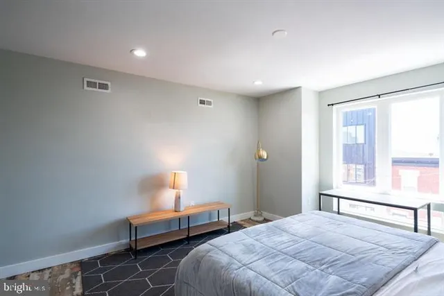 a bedroom with a bed and a window