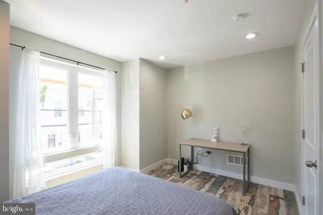 a bedroom with a bed and a window